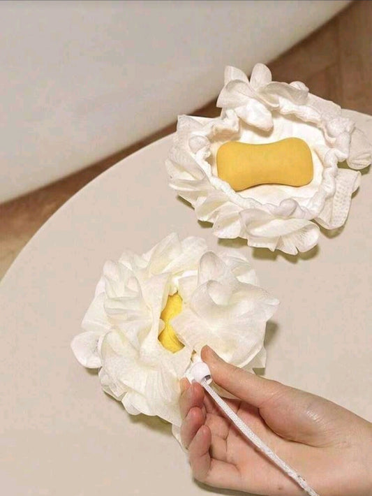 Flower-shaped bath loofah with built-in yellow soap, soft petals for gentle exfoliation, hand pulling cord to reveal soap
